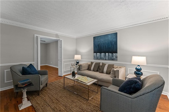 220 Hollyridge Dr, Roswell, GA 30076 - living room with a textured ceiling, wood finished floors, ornamental molding, and wainscoting