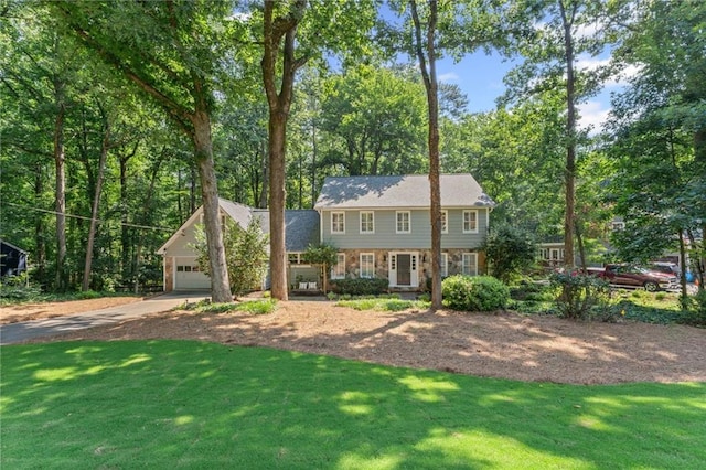 220 Hollyridge Dr, Roswell, GA 30076 - colonial inspired home with driveway, a front yard, stone siding, an attached garage, and view of wooded area