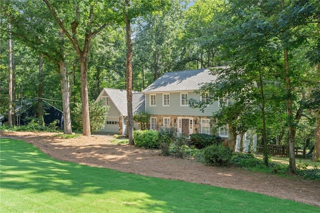 220 Hollyridge Dr, Roswell, GA 30076 - view of front facade featuring dirt driveway, an attached garage, stone siding, and a front yard