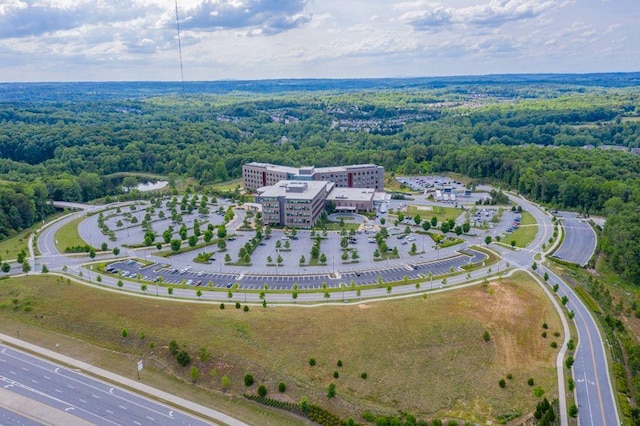 bird's eye view featuring a wooded view