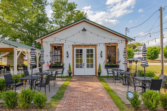 view of front of home with french doors and a patio