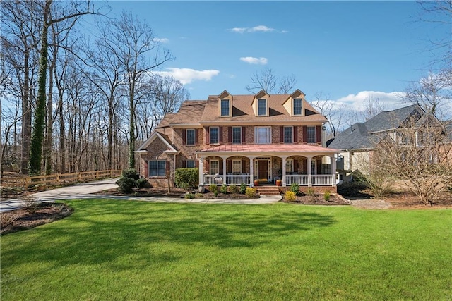 view of front of home featuring a front yard and covered porch