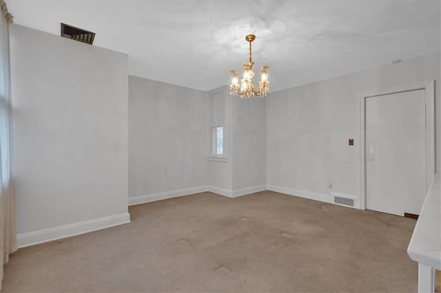 unfurnished room with visible vents, baseboards, and carpet flooring