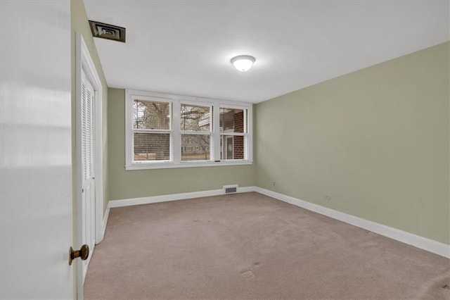 unfurnished room featuring visible vents, carpet flooring, and baseboards