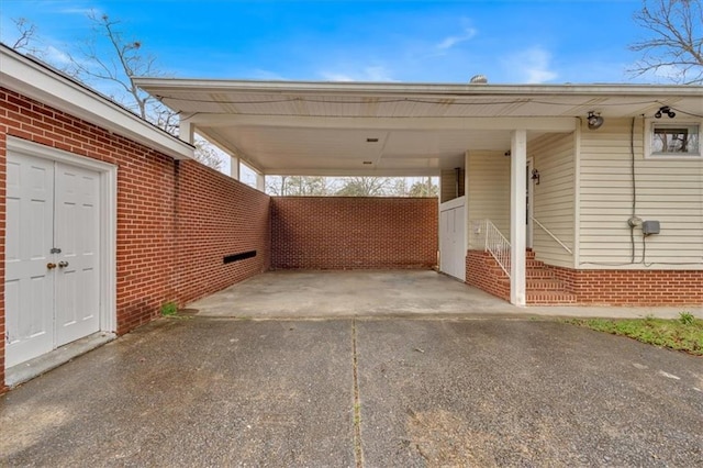 view of vehicle parking with aphalt driveway and a carport