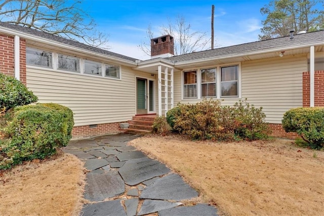 exterior space featuring a chimney and crawl space