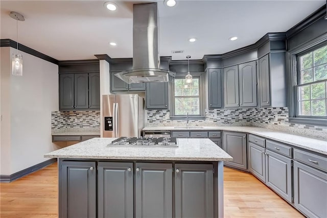 kitchen with stainless steel appliances, island exhaust hood, a center island, and gray cabinets