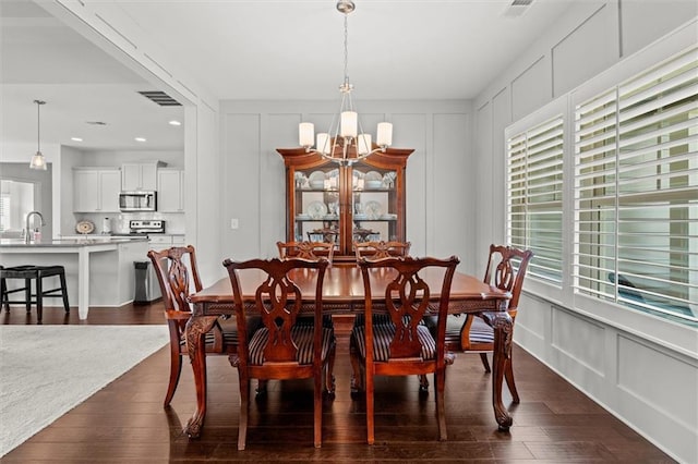 777 Tucker Trl, Bremen, GA 30110 - dining area featuring a decorative wall, a chandelier, dark wood-type flooring, and recessed lighting