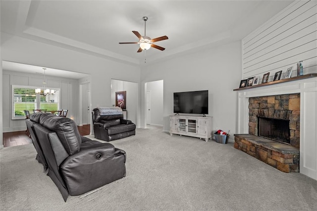777 Tucker Trl, Bremen, GA 30110 - carpeted living room with a raised ceiling, ceiling fan, a chandelier, a stone fireplace, and a high ceiling