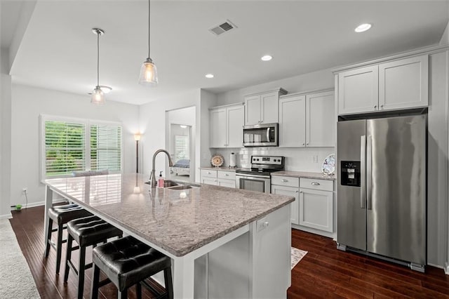 777 Tucker Trl, Bremen, GA 30110 - kitchen featuring appliances with stainless steel finishes, a sink, a kitchen island with sink, white cabinetry, and light stone countertops