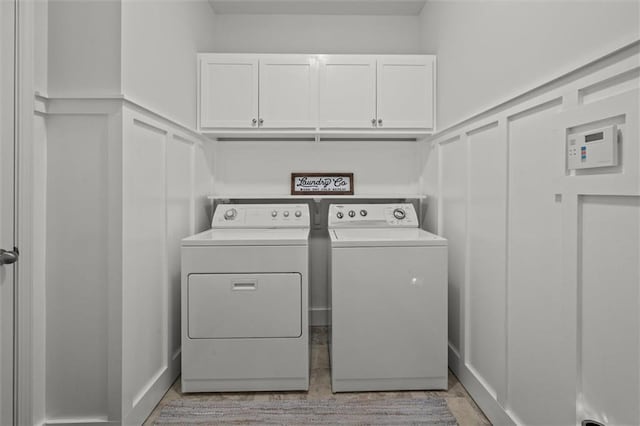 777 Tucker Trl, Bremen, GA 30110 - laundry room featuring washer and dryer, a decorative wall, cabinet space, and wainscoting