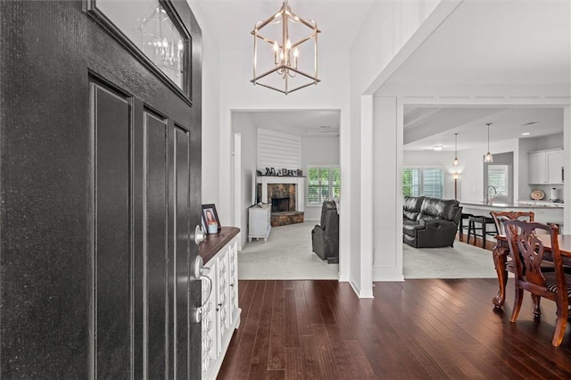 777 Tucker Trl, Bremen, GA 30110 - foyer featuring dark wood-type flooring, a chandelier, a fireplace, and baseboards