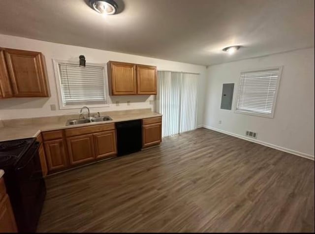 kitchen featuring dark wood-style flooring, visible vents, a sink, electric panel, and black appliances