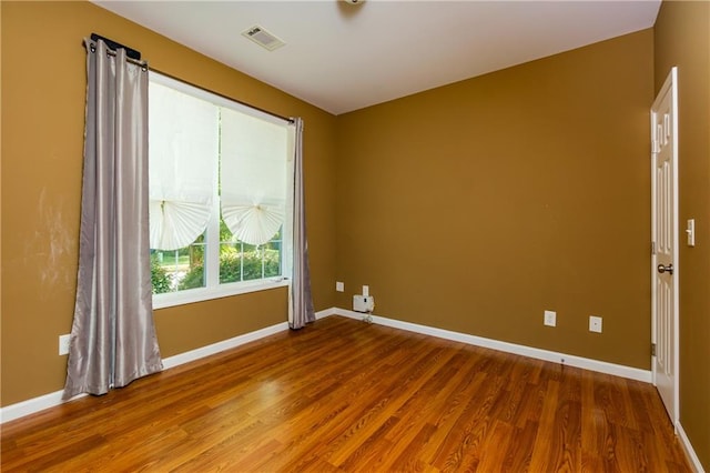 spare room with wood-type flooring