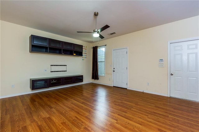 unfurnished living room featuring ceiling fan and light wood-type flooring