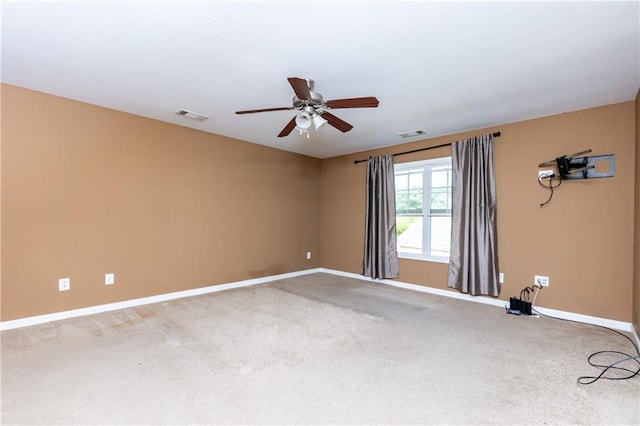 carpeted spare room featuring ceiling fan