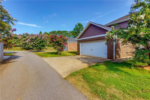 exterior space featuring a garage and a front yard