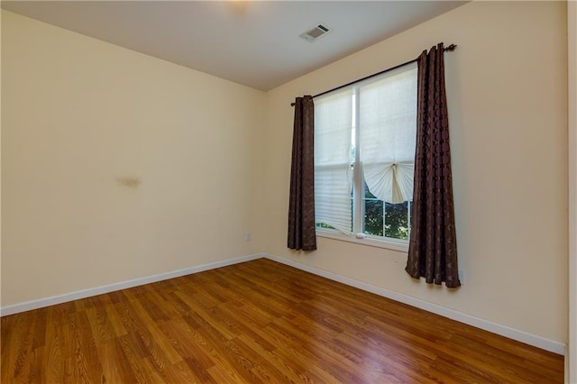 spare room featuring hardwood / wood-style floors