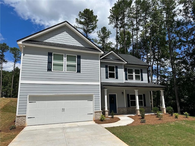 view of front of home with a garage, a front lawn, and a porch