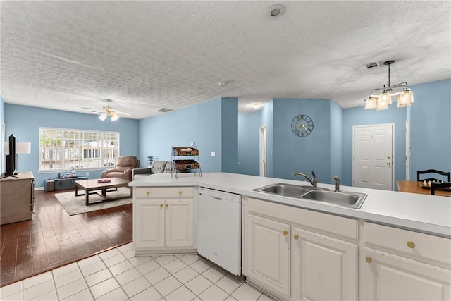 kitchen featuring ceiling fan, open floor plan, dishwasher, white cabinets, and a sink