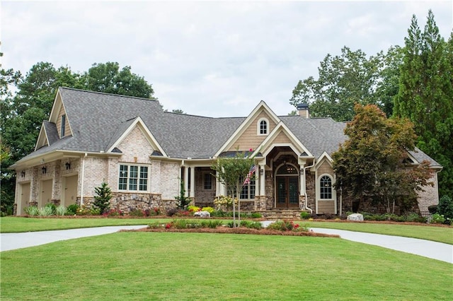 craftsman-style house featuring a garage and a front lawn