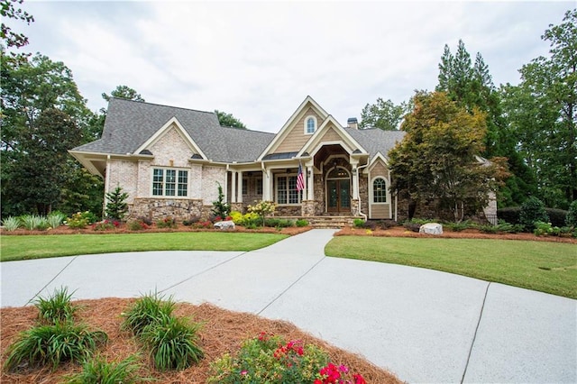 craftsman house featuring a front yard and a porch