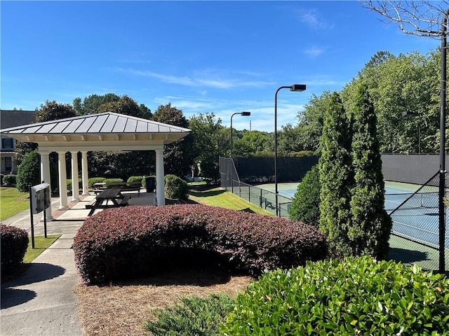 surrounding community with a gazebo and tennis court