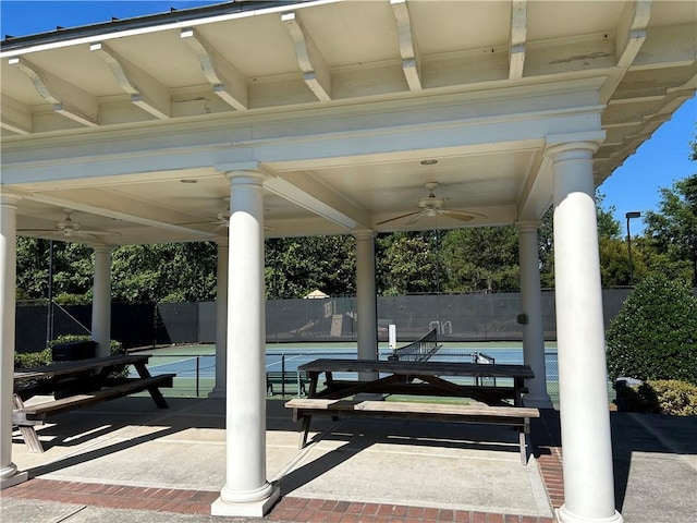 view of patio / terrace with a gazebo, tennis court, and ceiling fan