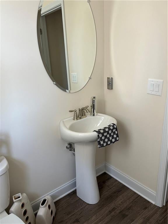 bathroom with wood-type flooring and toilet