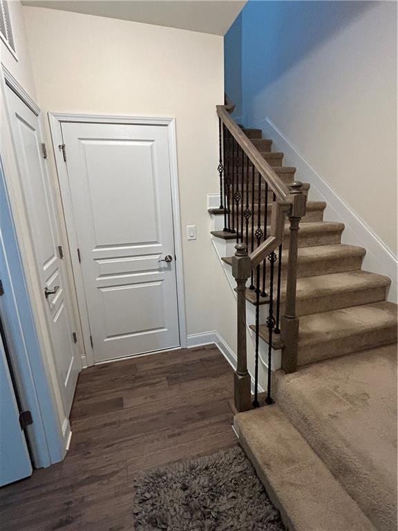 staircase featuring hardwood / wood-style flooring