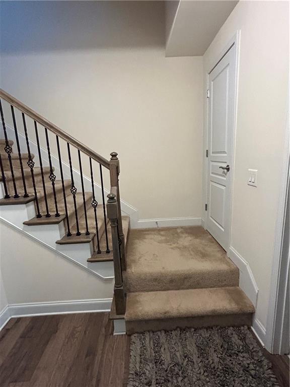 stairway featuring hardwood / wood-style flooring