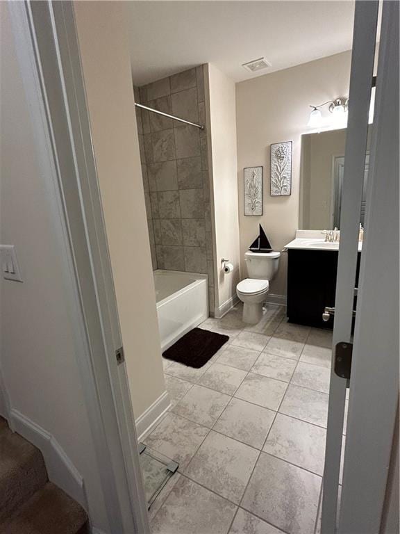 full bathroom with toilet, vanity, and tiled shower / bath combo