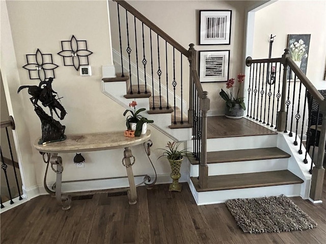 stairs featuring hardwood / wood-style floors