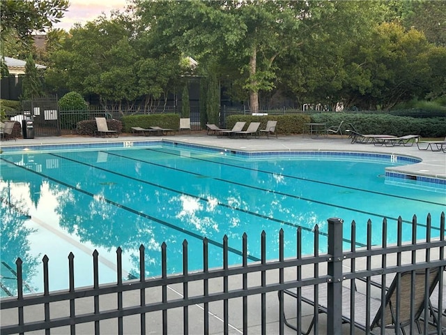 view of pool at dusk