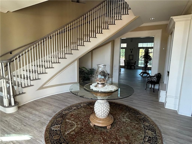 foyer entrance with dark hardwood / wood-style flooring and ornamental molding