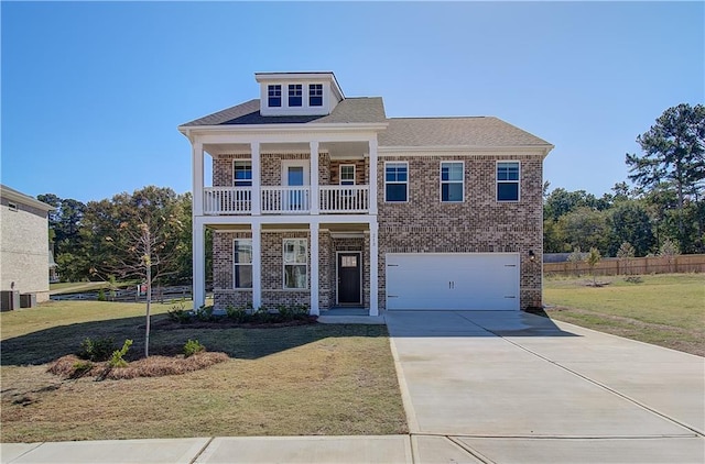 view of front facade with a balcony, a garage, and a front lawn