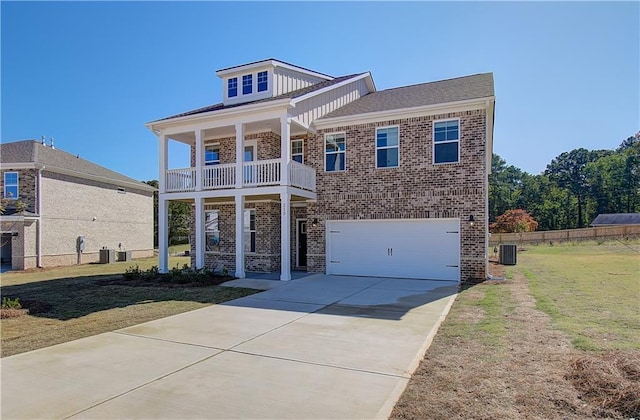 view of front of house featuring central AC unit, a garage, a front lawn, and a balcony