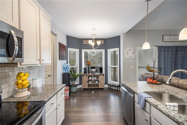 kitchen featuring pendant lighting, sink, white cabinetry, and stainless steel appliances