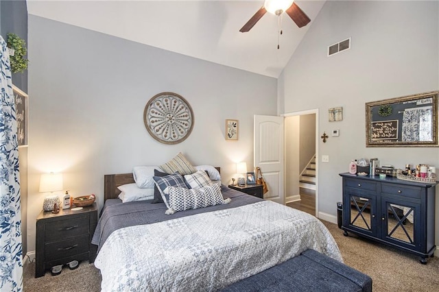 bedroom with ceiling fan, high vaulted ceiling, and light carpet