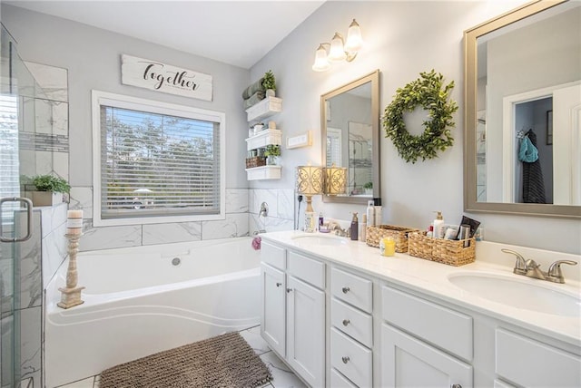 bathroom featuring vanity and independent shower and bath