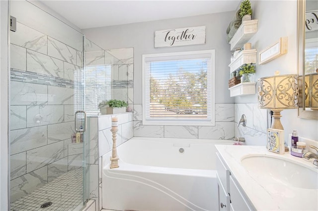 bathroom with vanity and independent shower and bath