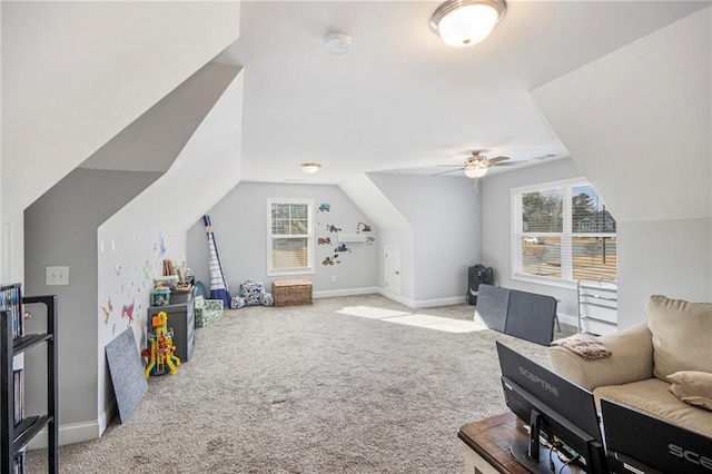 playroom featuring light carpet, lofted ceiling, and a healthy amount of sunlight