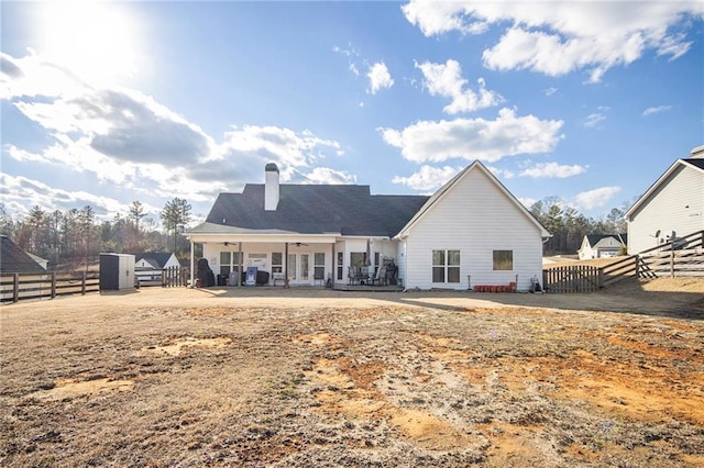 back of house featuring a storage shed and a patio area