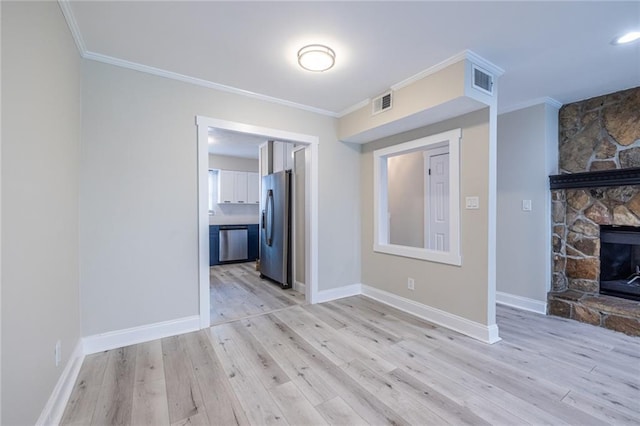 6700 Roswell Rd Unit 21E, Sandy Springs, GA 30328 - unfurnished living room featuring light wood-type flooring, crown molding, and a fireplace