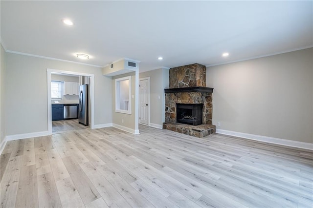 6700 Roswell Rd Unit 21E, Sandy Springs, GA 30328 - unfurnished living room with crown molding, light wood-style floors, a stone fireplace, and recessed lighting