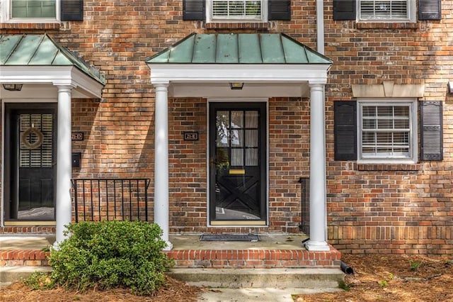 6700 Roswell Rd Unit 21E, Sandy Springs, GA 30328 - doorway to property with brick siding and a standing seam roof