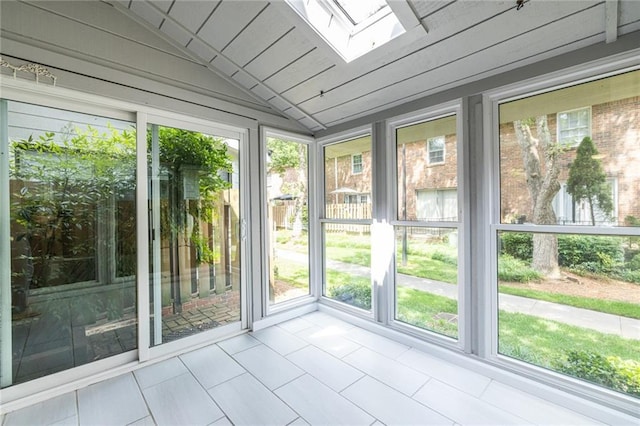 6700 Roswell Rd Unit 21E, Sandy Springs, GA 30328 - unfurnished sunroom featuring plenty of natural light, a skylight, tile patterned flooring, and vaulted ceiling