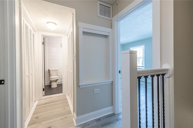 6700 Roswell Rd Unit 21E, Sandy Springs, GA 30328 - hallway with a textured ceiling and light wood-style flooring
