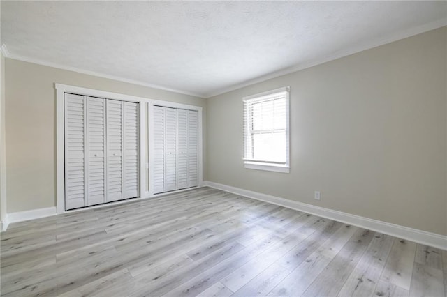6700 Roswell Rd Unit 21E, Sandy Springs, GA 30328 - unfurnished bedroom featuring light wood-style floors and ornamental molding
