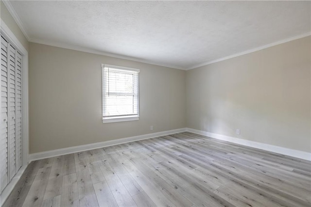 6700 Roswell Rd Unit 21E, Sandy Springs, GA 30328 - unfurnished bedroom featuring light wood finished floors, ornamental molding, and a closet